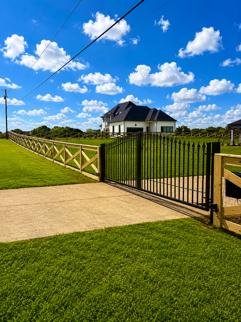 Pine crossbuck fence along a residential backyard