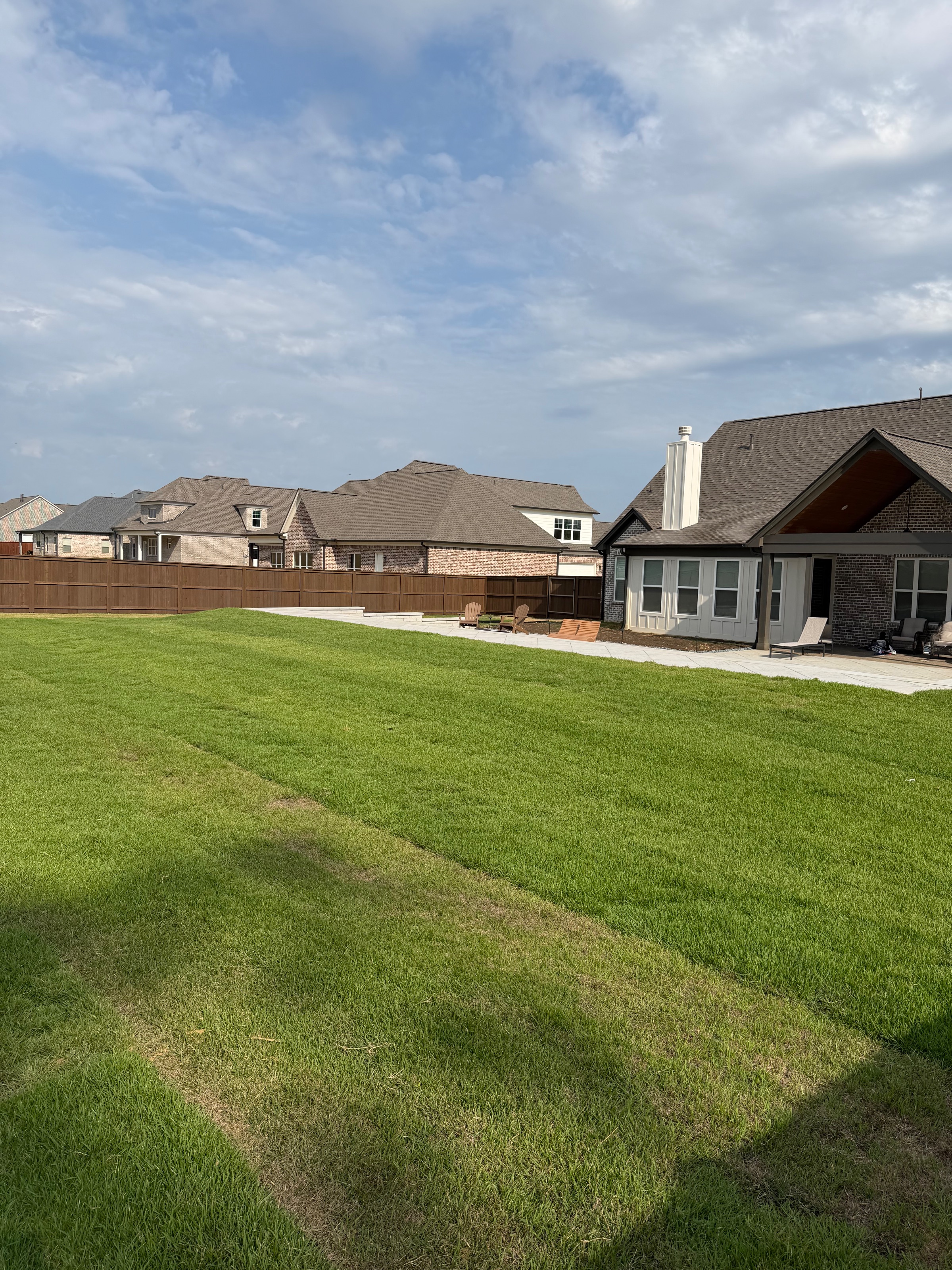Backyard fully enclosed with a pre-stained cedar privacy fence