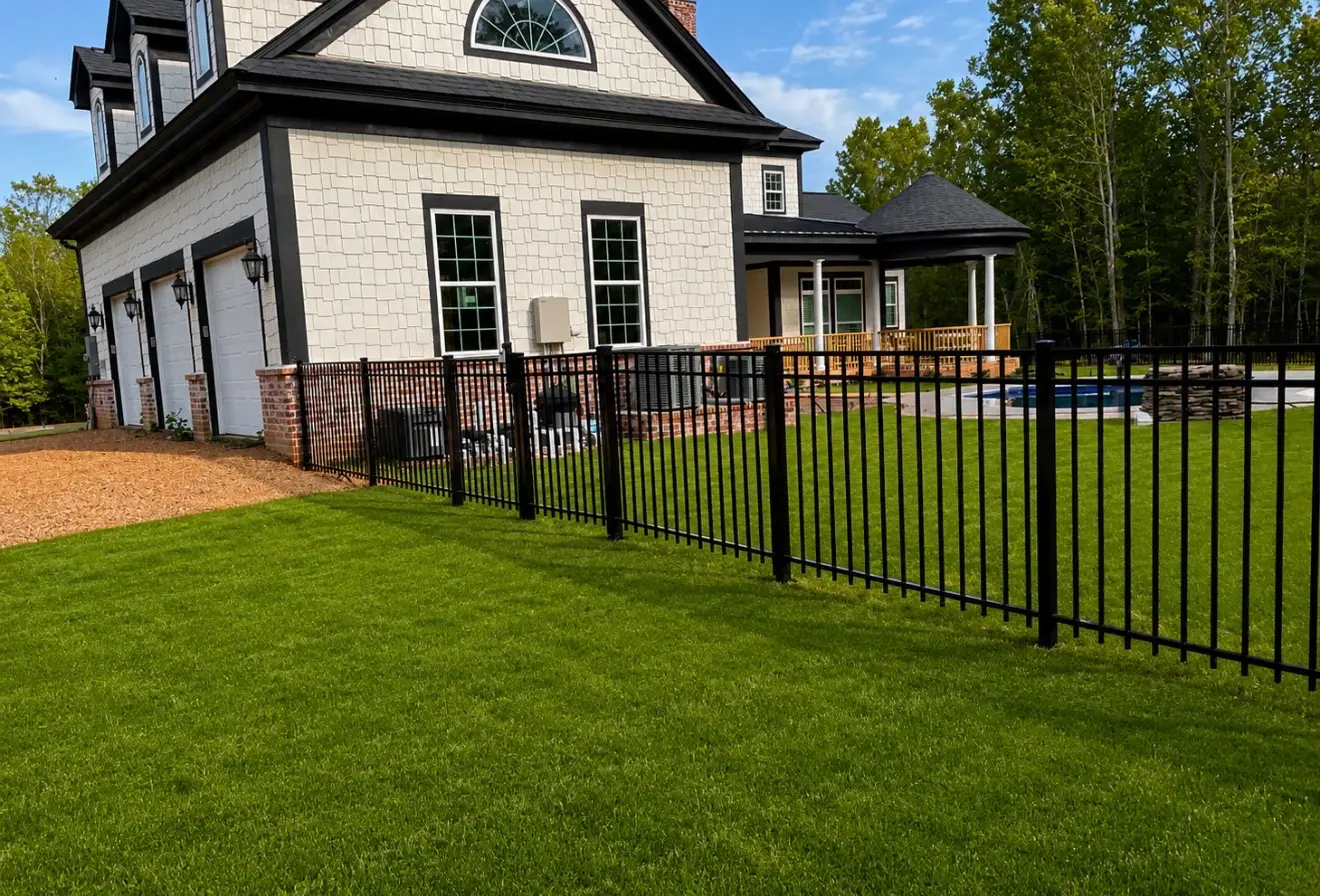 Black flat-top aluminum fence enclosing a backyard and pool area in Olive Branch, Mississippi